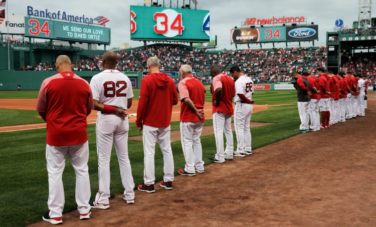 The Boston Red Sox and fans pause for a moment before Monday night's game for David Ortiz.
