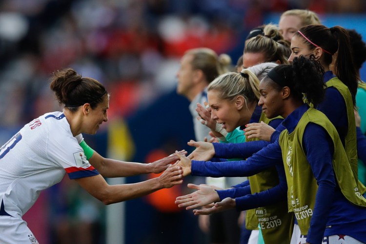 Carli Lloyd, left, celebrates with teammates after scoring the first goal is the U.S. women's soccer team's victory over Chile on Saturday in Paris, France. 