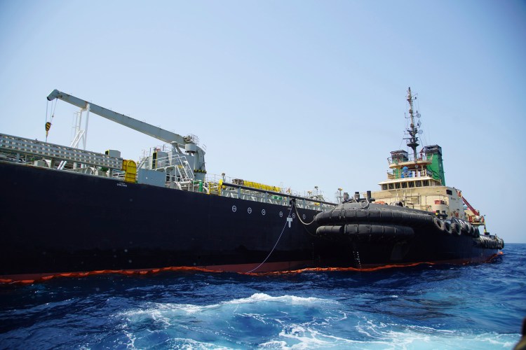 The Japanese-owned oil tanker Kokuka Courageous, which the U.S. Navy says was damaged by a mine, is anchored off Fujairah, United Arab Emirates, during a trip organized by the Navy for journalists Wednesday. The limpet mines used to attack the oil tanker near the Strait of Hormuz bore "a striking resemblance" to similar mines displayed by Iran, a Navy explosives expert said. Iran has denied being involved. 