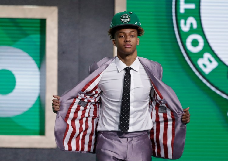 Indiana's Romeo Langford shows off his jacket lining, with Indiana colors, after the Boston Celtics selected him as the 14th pick in the NBA draft on Thursday.