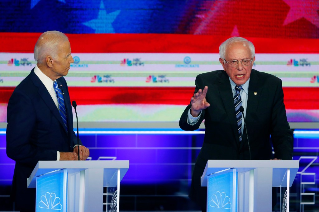Sen. Bernie Sanders, I-Vt., speaks during Thursday night's Democratic debate as former Vice President Joe Biden watches. The debate underscored the deep ideological divisions among the Democratic candidates for president.