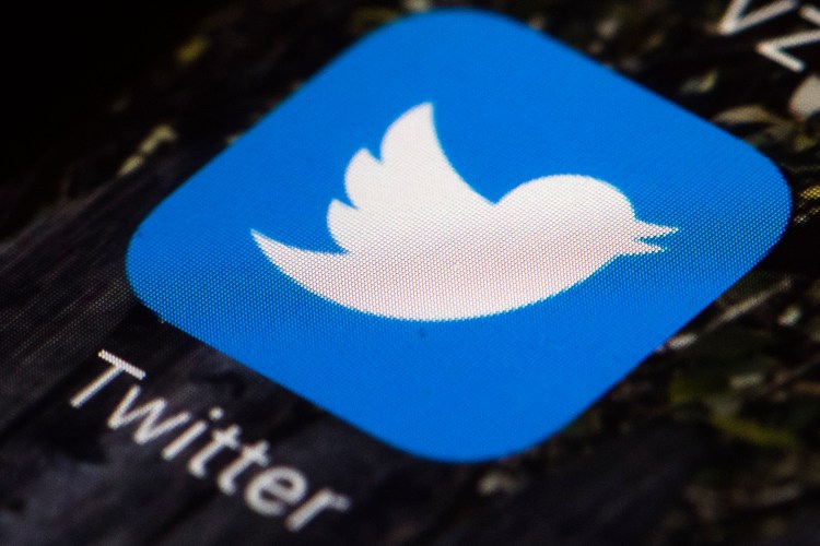 This April 26, 2017 file photo shows the Twitter app icon on a mobile phone. Twitter said Thursday it would adds labels for tweets that break its rules, including those of political figures and government officials.