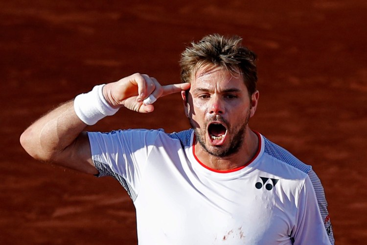 Switzerland's Stan Wawrinka celebrates winning his fourth round match of the French Open tennis tournament against Greece's Stefanos Tsitsipas in five sets, 7-6 (8-6), 5-7, 6-4, 3-6, 8-6, at the Roland Garros stadium in Paris, Sunday, June 2, 2019. (AP Photo/Christophe Ena )