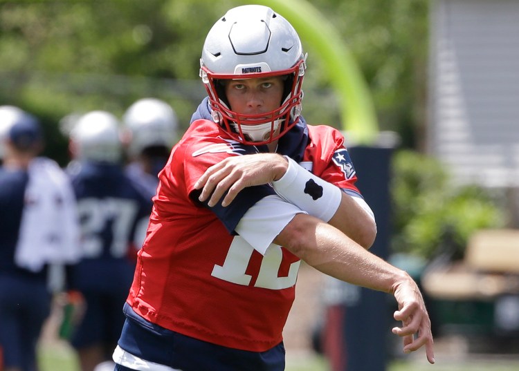 New England Patriots quarterback Tom Brady follows through after throwing the ball during a minicamp practice Tuesday in Foxborough, Mass.