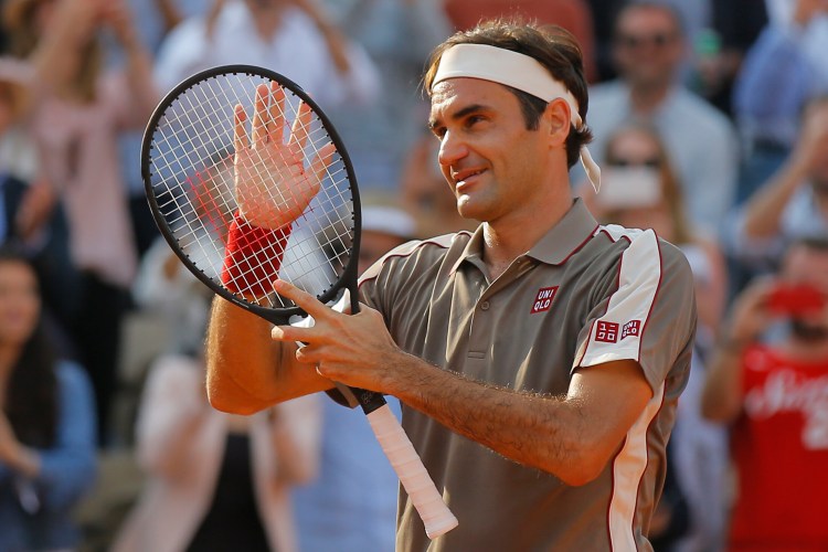 Switzerland's Roger Federer celebrates winning his quarterfinal match of the French Open against Switzerland's Stan Wawrinka in four sets, 7-6 (7-4), 4-6, 7-6 (7-5), 6-4, at the Roland Garros stadium in Paris, Tuesday.