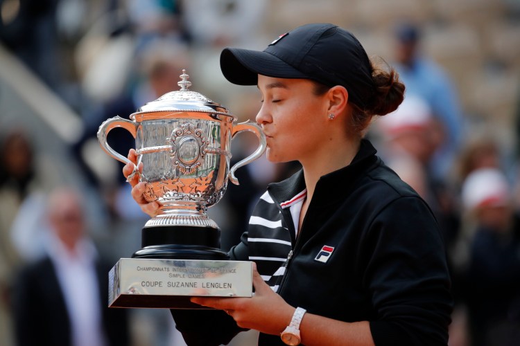 Ash Barty kisses the trophy after winning her first major championship, beating Marketa Vondrousova 6-1, 6-3 in the French Open final on Saturday in Roland Garros Stadium in Paris.