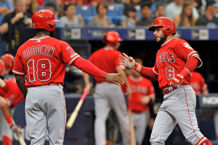 The Angels' Brian Goodwin, left, celebrates with David Fletcher after Fletcher's two-run home run off Tampa Bay Rays starter Charlie Morton in the second inning of the Angels' 5-3 win Saturday in St. Petersburg, Fla. 
