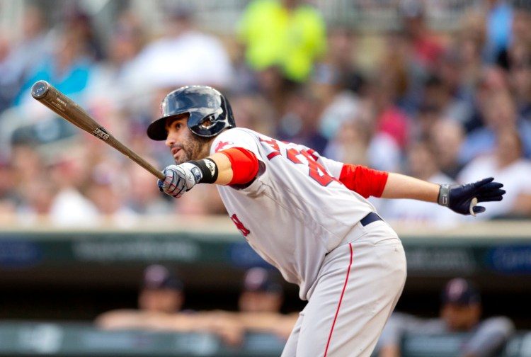 Boston's J.D. Martinez hits and RBI single in the first inning against the Minnesota Twins on Monday in Minneapolis.