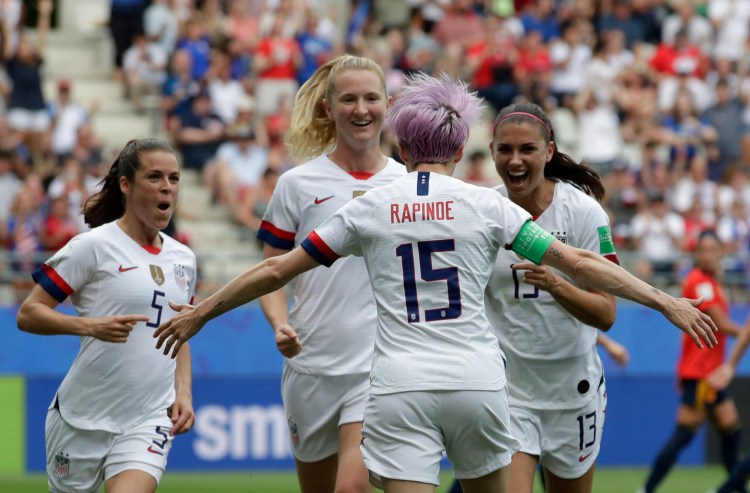 Megan Rapinoe of the United States, front, celebrates with teammates after scoring the opening goal from a penalty kick during Monday's Round of 16 win over Spain at the women's World Cup.
