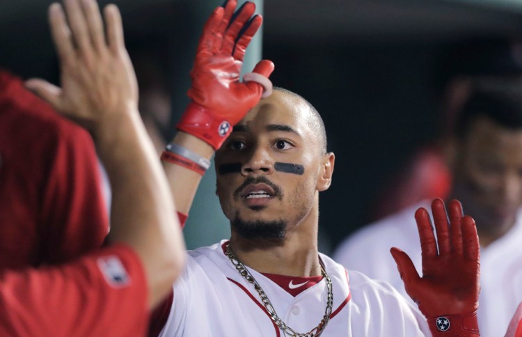 Boston's Mookie Betts is congratulated after his solo home run in the seventh inning of the Red Sox' 6-5 win over the Chicago White Sox on Monday in Boston.