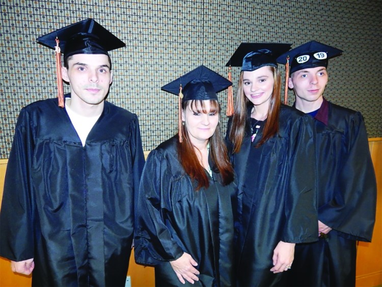 Four members of one family received their highs school diplomas during the Biddeford Adult Education graduation on Wednesday night. From left are Nicholas Bruns, Tina Bruns, Ashleigh Ouellette and Terry Nowlin. Tina Bruns is the mother of Nicholas Bruns, Ashleigh Ouellette and Terry Nowlin. 