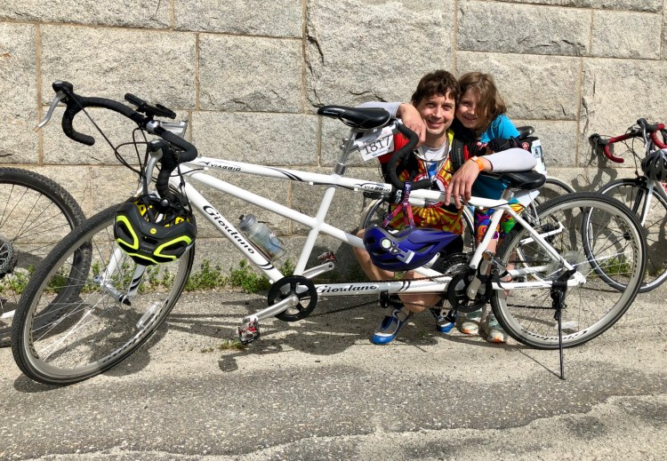 Bryan and Maggie McCarthy pose with their tandem bicycle at the Augusta Waterfront Park on Sunday, the third day of the Trek Across Maine.