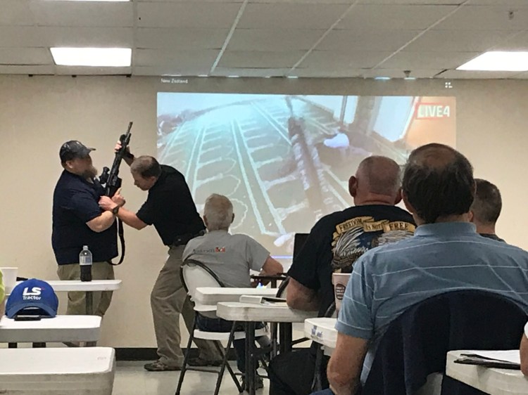Peter Joyce, of Special Reaction Team Concepts, demonstrates on Saturday how to disarm an intruder. He was addressing representatives of several central Maine religious groups in Winslow.