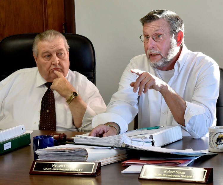 Somerset County Commissioner Newell Graf Jr., right,  speaks to an opponent of the CMP corridor project Nov. 7, 2018, during a sometimes heated meeting in Skowhegan. At left is Commissioner Lloyd Trafton, who tendered his resignation from the board of Western Mountains & Rivers Corp. on Friday after he was accused of having conflict of interest. Western Mountains received $22 million from CMP to support its NECEC transmission line proposal through Somerset County.