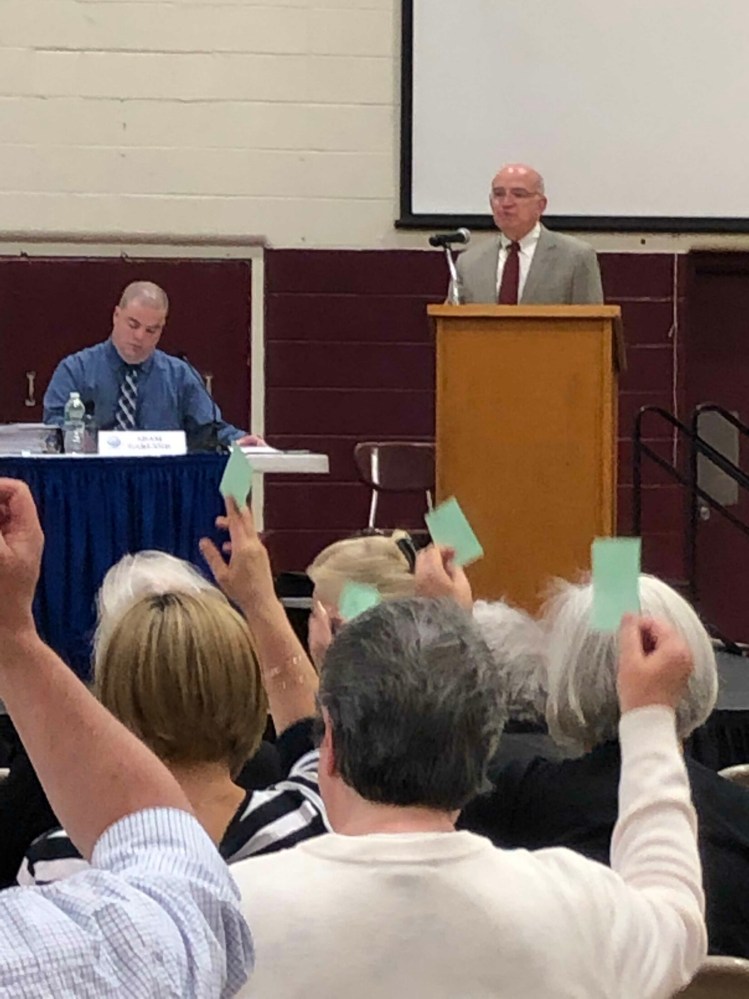 Richmond Town Manager Adam Garland, left, and Town Meeting moderator William Dale watch town residents vote at the annual Town Meeting Tuesday.