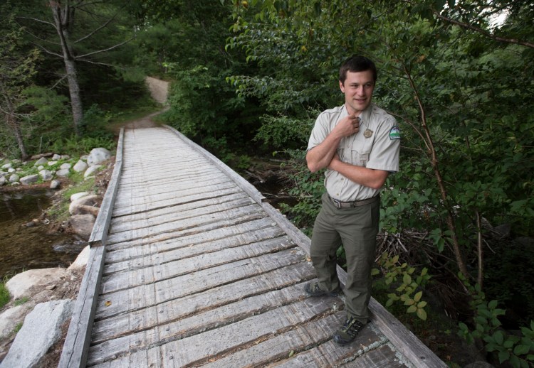 Baxter State Park Director Eben Sypitkowski waits to cross a snowmobile bridge at Abol Stream on his way to inspect recent trail improvements at the park last August, two months after he took over as director. 
