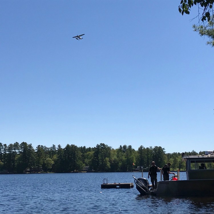 Maine Warden Service dive boat and aircraft on Watchic Lake on Saturday.