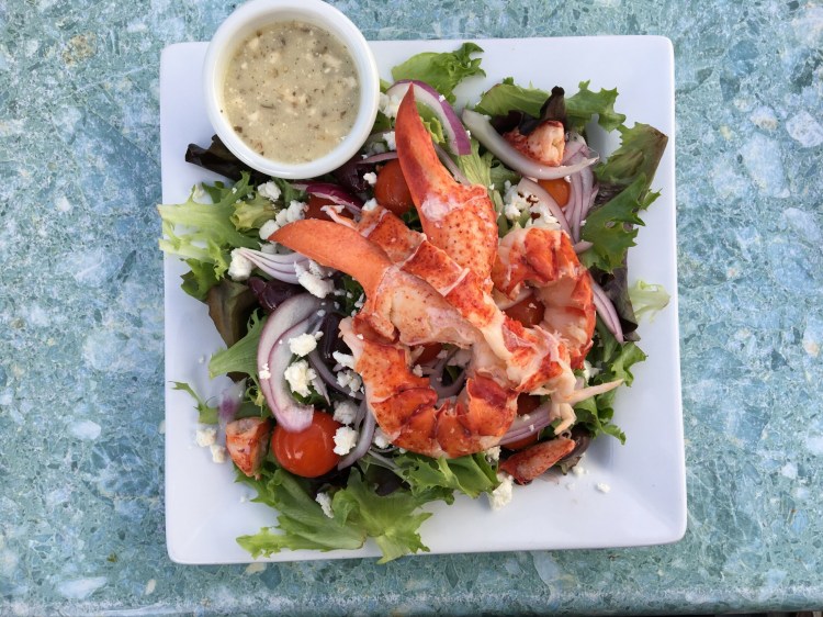 The Greek salad at The Bait Shed in Scarborough is loaded with feta and kalamata olives, a treat in itself. But add lobster and it's a full meal. The view - even at low tide - is a peaceful, wild experience. Photo by Staff Writer Deirdre Fleming