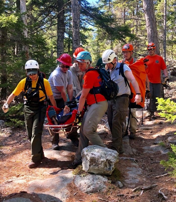 Rescuers carry out one of the two hikers who fell in Acadia.