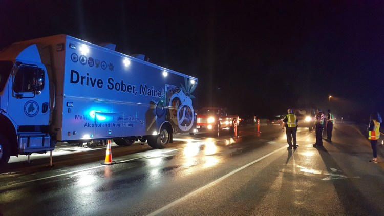 Officials from the Sagadahoc County Regional Impaired Driving Enforcement Team conduct a checkpoint on July 1, 2017, on Route 196 in Topsham.