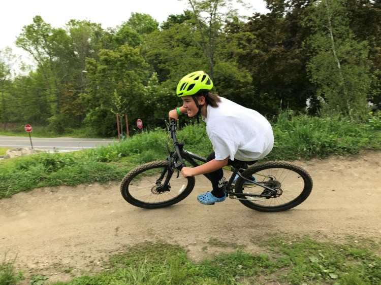 Adryana White leans into a berm at the Bath Pump Track at Bath Middle School in June, when she was a seventh grader at the school. 