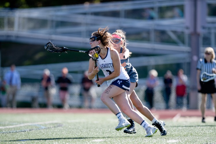 Yarmouth's Abi Thornton drives past Biddeford's Grace Boisvert during the Clippers' 11-6 win in a Class B semifinal on Tuesday in Yarmouth.