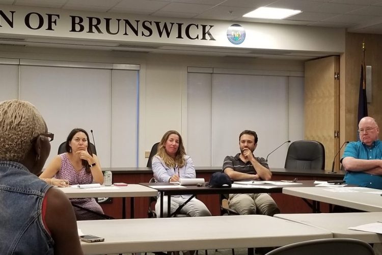 From left, School Board members Celina Harrison and Sarah Singer, Town Councilor Dan Ankeles and Town Manager John Eldridge meet with Mufalo Chitam, executive director of the Maine Immigrants’ Rights Coalition. School, town and outside officials met for the first time Wednesday night to start the process of establishing a system to help serve the asylum seekers entering Brunswick.