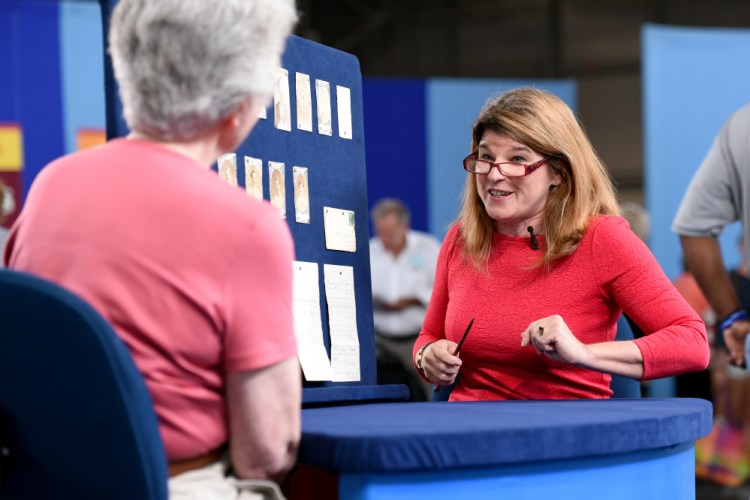 This Aug. 9, 2014 photo released by "Antiques Roadshow" shows Leila Dunbar appraising a collection of early Boston baseball memorabilia for the program in New York. 
