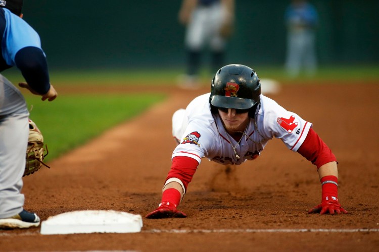 Portland's' Brett Netzer dives back into face on a pickoff attempt during the Sea Dogs' 7-1 win over the Trenton Thunder on Monday at Hadlock Field. 