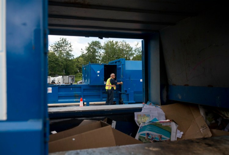 Chuck Catroppo works a compactor at the Cape Elizabeth transfer station on July 1.
