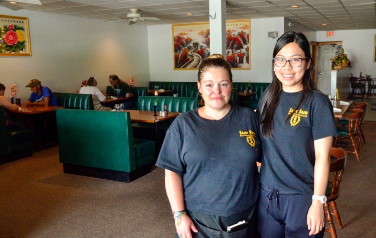 Erin Pushard, left, and Honchi Fung stand by the door Tuesday at Sun Sun Fine Chinese Restaurant in Randolph.