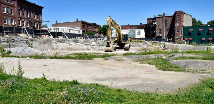 An excavator moves into the site for the new Lockwood Hotel in downtown Waterville on Monday.