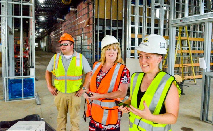 Principal Mel Burnham Barter, right, RSU 2 Superintendent Cheri Towle, center, and construction Superintendent Grit Richards, of PC Construction talk about the library Wednesday during a tour of Monmouth Memorial School, the new pre-K to 8th grade school being built in Monmouth.