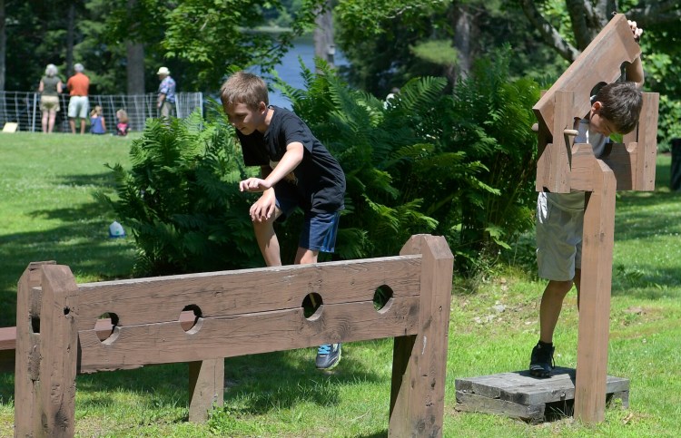 Children play on the stockade Sunday during Dresden Summerfest.