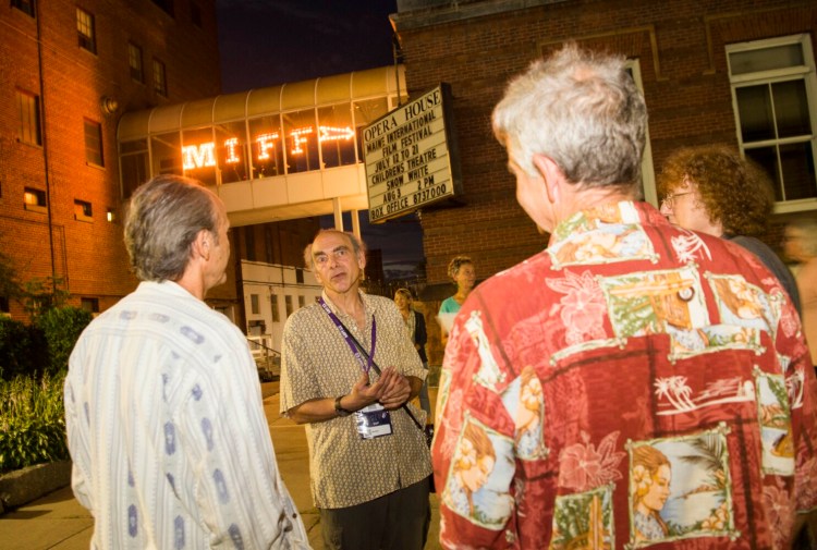 Ken Eisen, facing forward, speaks with protesters before the Wednesday night showing of the controversial film "Last Tango in Paris" during the Maine International Film Festival at the Waterville Opera House. 