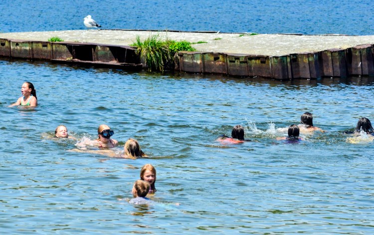 People swim in Maranacook Lake on Friday at the Winthrop town beach.