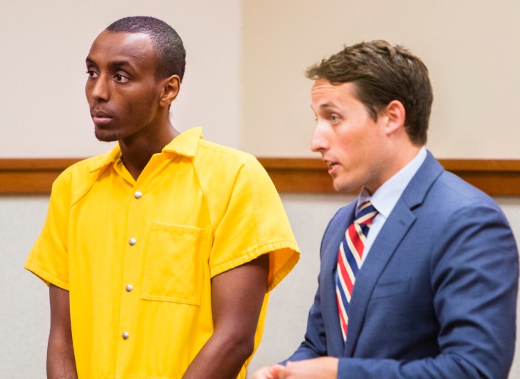 Mohamed Noh appears with his defense attorney  in Cumberland County Superior Court in Portland on Monday, on charges that he stabbed his mother in their Harrison home on Friday. 
