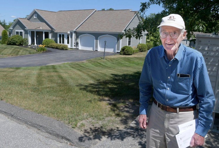 Granite Hill Estates resident Jack Smart, 94, checks the mail Thursday near his home.