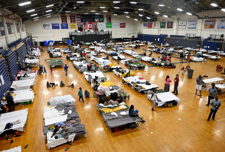 This file photo shows asylum-seekers housed in the city's temporary shelter at the Portland Expo on July 24. 