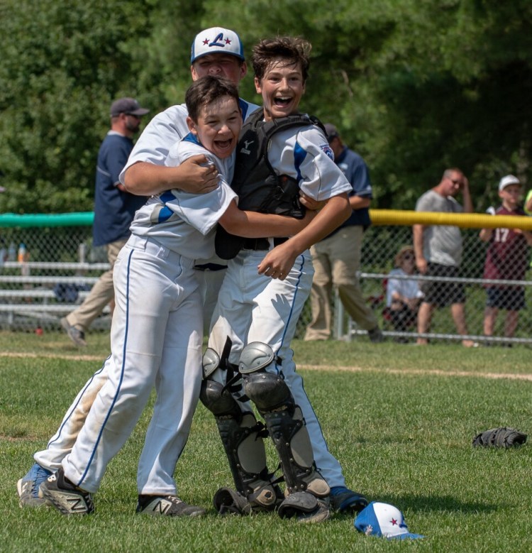 Lewiston relief pitcher Ethan Blue, center, reacts after recording the final out in his team's 8-4 victory over York Saturday at Elliot Avenue Little League Field in Lewiston to capture the state championship and advance to the regional finals in Connecticut where they will take on Massachussetts on Sunday.  Celebrating with Blue are Joe Dube and Mike Caron, right.
