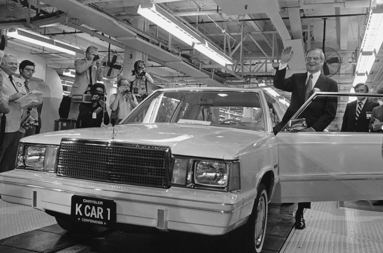 Chrysler Chairman Lee Iacocca steps into the first K-Car at ceremonies in Detroit, Mich., on Aug. 6, 1980. The new front-wheel-drive compact was driven out of the plant past cheering auto workers by Iacocca. Iacocca, who became a folk hero for rescuing the company in the '80s, died Tuesday. He was 94.