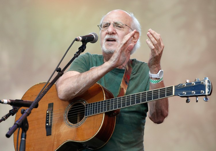 In this July 20, 2014, file photo, singer-songwriter Peter Yarrow, of the 1960's era musical trio "Peter Paul and Mary," claps and encourages the audience to sing along during a memorial tribute concert for folk icon and civil rights activist Pete Seeger at Lincoln Center's Damrosch Park in New York. 