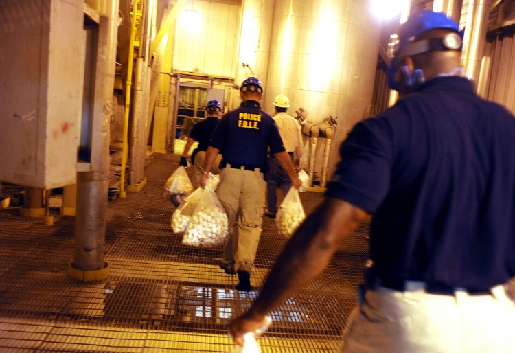 Florida Department of Law Enforcement officers carry bags of prescription drugs that were confiscated from a clinic to be burned in an incinerator facility in Coconut Creek in 2011. 