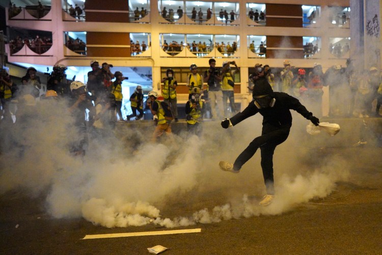 A protester kicks a tear gas canister during a confrontation in Hong Kong on Sunday. 

