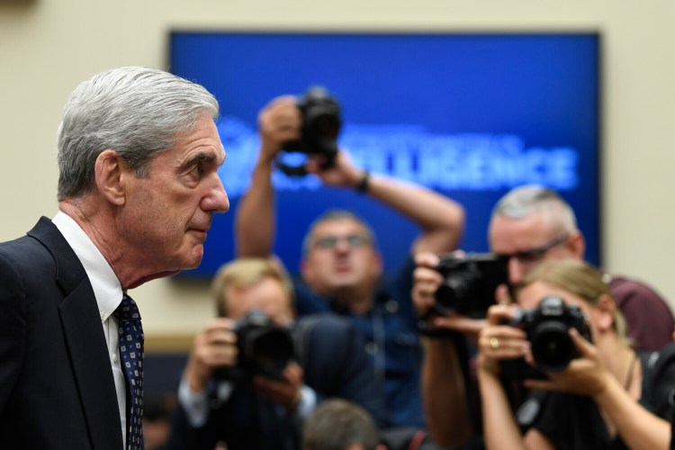 Former special counsel Robert Mueller returns to the witness table after a break in his testimony before the House Intelligence Committee on Wednesday. 