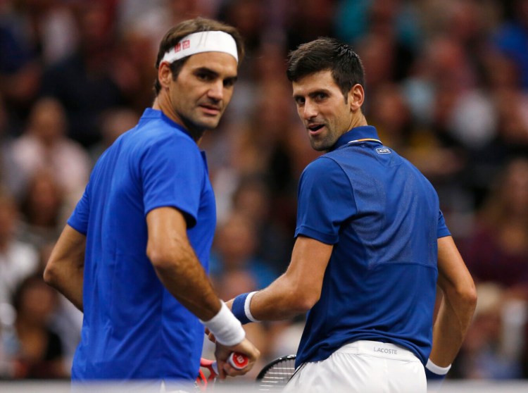 Roger Federer, left, and Novak Djokovic played for Team Europe in the Laver Cup in September, but face each other in the Wimbledon men's final on Sunday. 