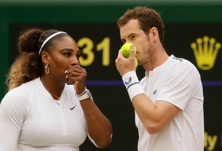 Serena Williams, left, talks with Andy Murray in between points during a mixed doubles match at Wimbledon on Saturday.
