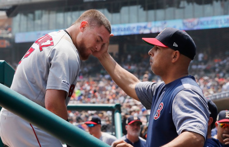 Christian Vazquez is greeted by Manager Alex Cora after a two-run home run during Boston's 6-3 win over the Detroit Tigers on Sunday in Detroit.