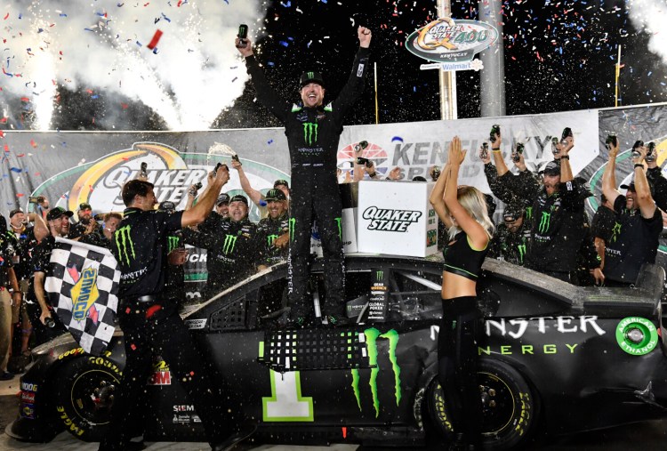 Timothy D. Easley/Associated Press
Kurt Busch celebrates his hold off his brother, Kyle, to win the NASCAR Cup Series race on Sunday at Kentucky Speedway in Sparta, Kentucky.