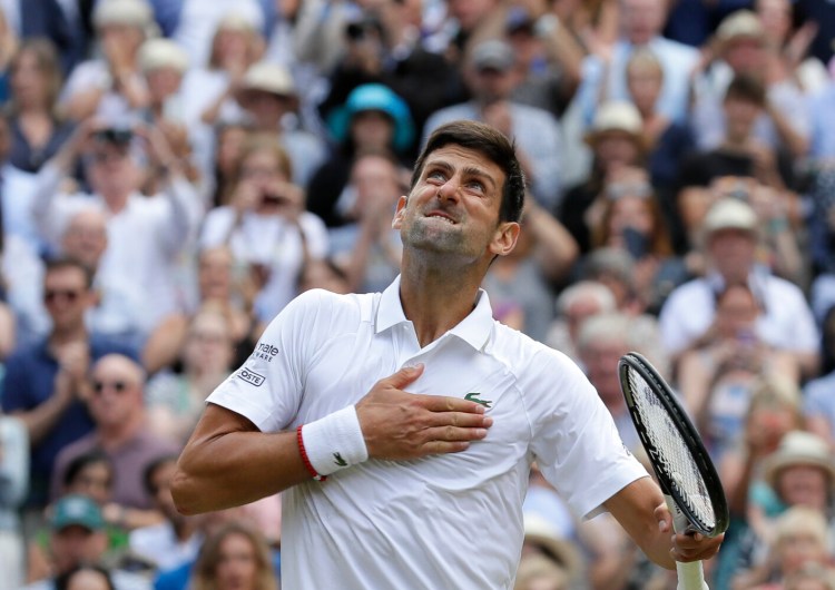 Novak Djokovic celebrates after defeating Roger Federer 7-6 (5), 1-6, 7-6 (4), 4-6, 13-12 (3) in the Wimbledon men's final to win his 16th Grand Slam title, on Sunday in Wimbledon, England.